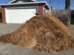 A big pile of mulch on a suburban driveway