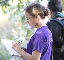 Woman taking notes on a notepad.