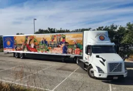 An 18 wheeler truck that has the food forward label on it