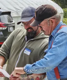 Two men looking at a document.