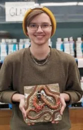 UC Davis entomology major Oliver Smith and the stick insect he created for the mural.