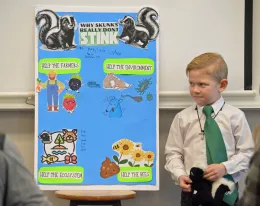 4-H youth member giving presentation on skunks