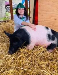 4-H youth member posing with swine