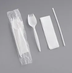 Single-use spork kit containing a spork, napkin, and straw wrapped in plastic.