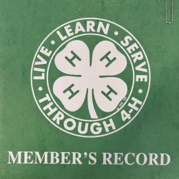A 4-H record book cover with a clover and MEMBER'S RECORD text
