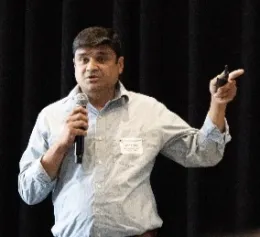 Tapan speaks into mic