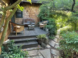 Garden landscape with deck, lush plantings and pathways