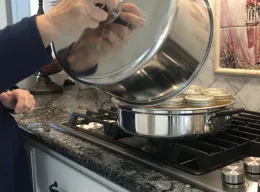 Lid being remove from canner