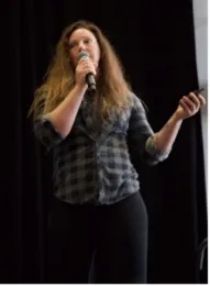 Sara speaks into mic