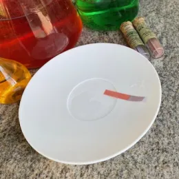 Blue litmus paper turns pink after being dipped in an acid solution