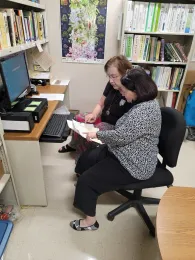 Master Gardeners in the Help Line Office doing research