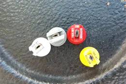 four different nozzle options for backpack sprayer in a metal bowl