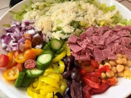 Ingredients for Italian chopped salad in a bowl, fresh garden vegetables