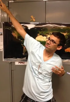 Entomology major Joel Hernandez strikes a walking stick pose. (Photo by Fran Keller)