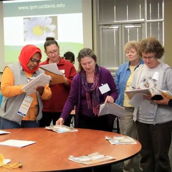 Volunteers reading from handouts during a class.