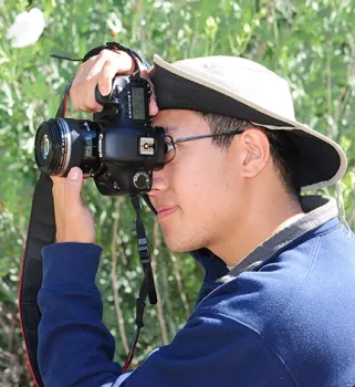 Alex Nguyen of UC Davis, who attended BugShot Hastings, focuses his camera. He is a 2015 alumnus of UC Davis with a bachelor's degree in entomology. (Photo by Kathy Keatley Garvey)