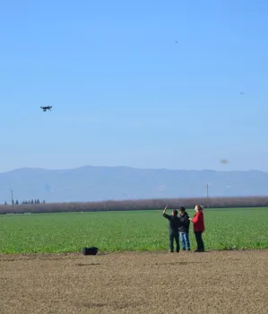 Sandoval-Solis Hydrology Lab graduate students using drone to capture aerial video data of + and – cover crop study field at Sano Farms in Firebaugh, CA, February 5, 2016