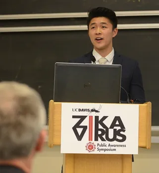 Biochemistry student Christian Wirawan introduces Dr. Regina Celi Ramos, a pediatrician from Brazil, who Skyped in. Wirawan was among the 18 student organizers. (Photo by Kathy Keatley Garvey)