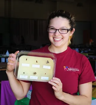 Julianna Payne of Vallejo holds a science project, the work of Joseph Garrett of Fairfield. (Photo by Kathy Keatley Garvey)