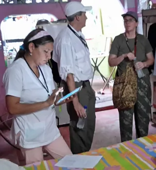UC Davis epidemiologist Amy Morrison (background) confers with her colleagues.