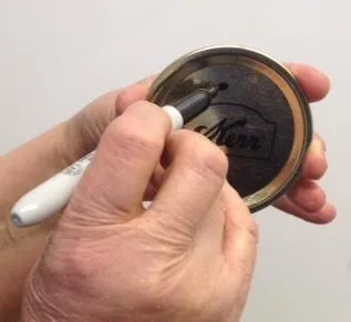 Mark lids once they are used to easily keep them separate from new lids. Photo credit: UC Master Food Preserver Program.
