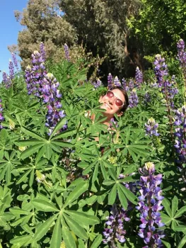 Emily Dorrance, former team leader and now BOG volunteer, in a patch of lupine.