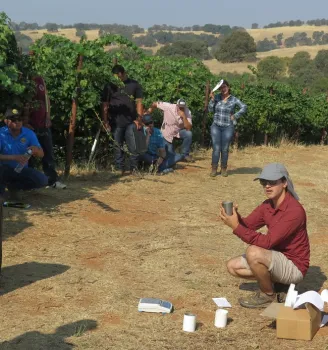 A young man with soil canisters and a scale.
