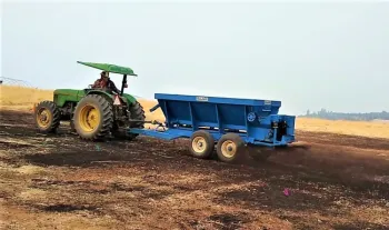 Spreading compost in the field research plots