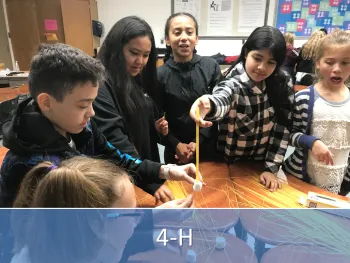 Children creating with dry spaghetti and marshmallows.