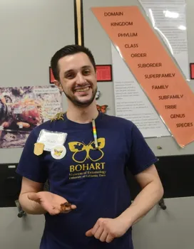 Wade Spencer with a scorpion on his shoulder and one in his hand. (Photo by Kathy Keatley Garvey)