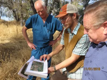 NRCS Soil scientist Andrew Brown (in cap) shows Tuolumne property owner Tim Moreno and Tuolumne Supervisor John Gray the soil map.
