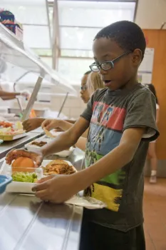 Child in school meal lunch line