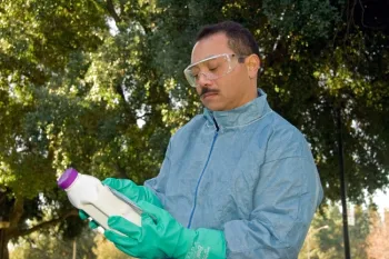 Reading the pesticide label. (Credit: ML Poe)