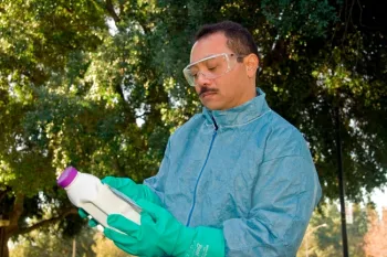 Reading the pesticide label. (Credit: ML Poe)