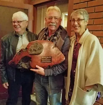 John Harper, center, shown with Mel George and Harper's wife, Amy.