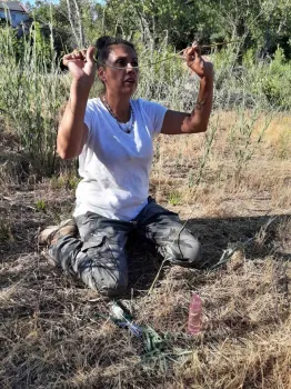 Ali Meders-Knight with willow stem whose leaves have been stripped to make willow juice, Laura Lukes