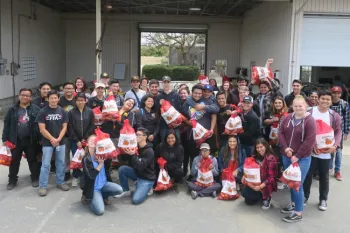 Students pose proudly with their harvested produce