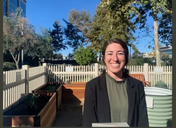 Rebeca Appel, program manager for the county's Land Use and Environment Group, smiles in the garden
