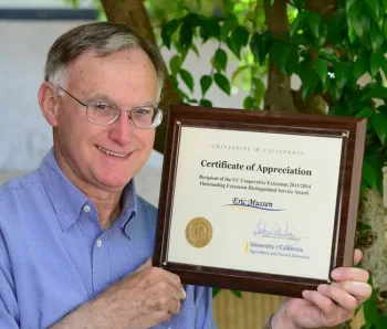 Eric Mussen with his 2013-14 Distinguished Service Award for Outstanding Extension from the UC Agriculture and Natural Resources. (Photo by Kathy Keatley Garvey)