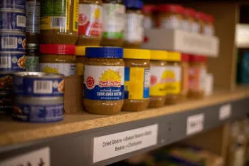 A shelf of dry goods on a food pantry shelf