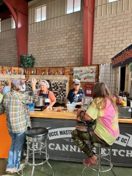Four women sitting and standing next to each other while having a conversation.