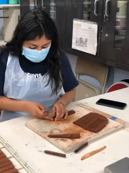 Alondra Bravo-Garcia making trim pieces.