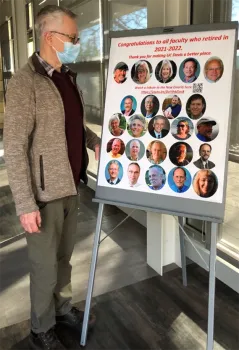 UC Davis distinguished professor Walter Leal looks at a poster congratulating UC Davis emeriti.