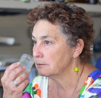Amina Harris, director of the UC Davis Honey and Pollination Center, tasting honey. (Photo by Kathy Keatley Garvey)