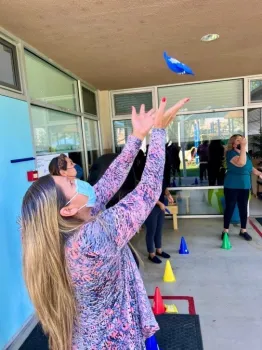 Teachers toss a bean bag during CATCH ECE training