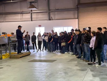 Donald Cleek (LREC Superintendent) speaking to local students about assessing fruit quality using the packline.