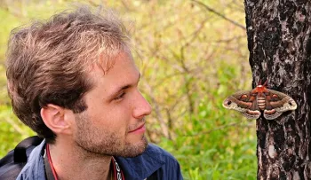 Sam Jaffe, founder and executive director of The Caterpillar Lab, looking at a 