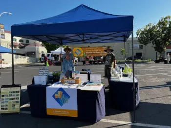 3 Master Gardeners staffing info booth at Farmers Market