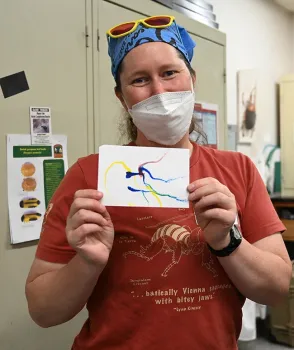 At the Bohart Museum open house, Tabatha Yang, education and outreach coordinator, drew the first Maggot Art as an example of what folks can do. (Photo by Kathy Keatley Garvey)