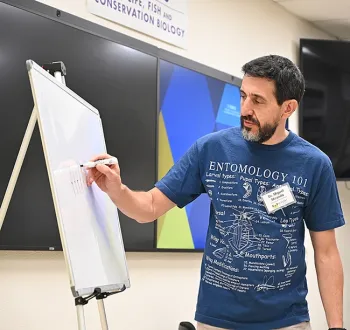 Professor Miguel Angel Miranda of the University of the Balearic Islands (UBI), Spain, says to think of an insect's main characteristics.(Photo by Kathy Keatley Garvey)